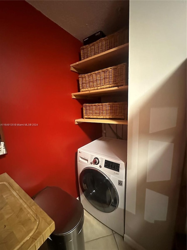 laundry area with washer / dryer and tile patterned floors