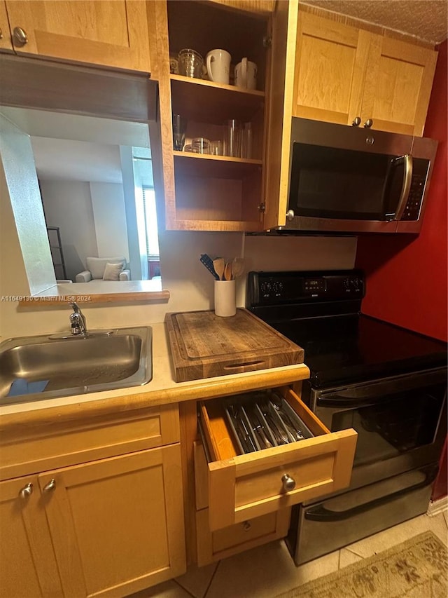 kitchen featuring light tile patterned flooring, sink, and electric range