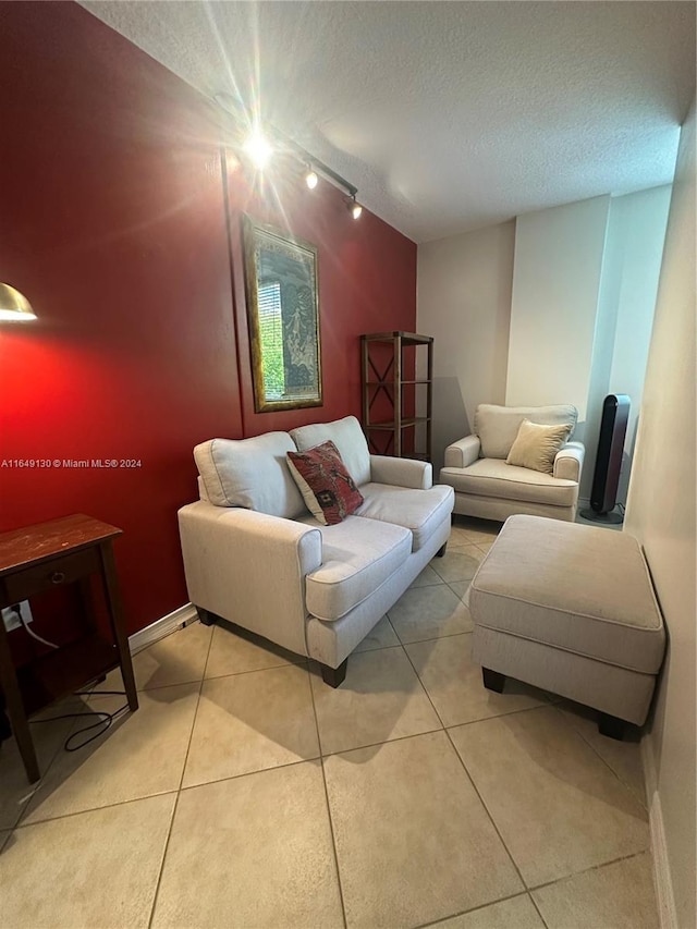 tiled living room with rail lighting and a textured ceiling