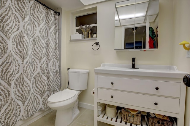 bathroom with toilet, vanity, tile patterned floors, and walk in shower