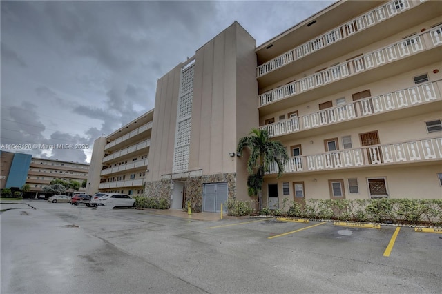 233 NE 14th Ave Unit 304, Hallandale Beach, FL 33009 - view of apartment building / complex featuring uncovered parking