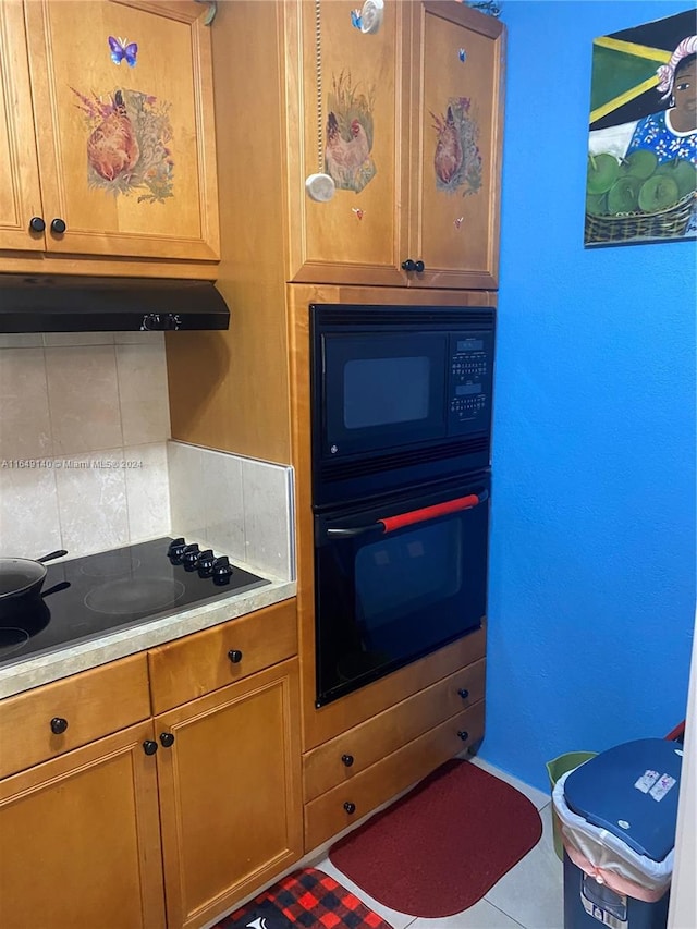 kitchen featuring black appliances, tasteful backsplash, and tile patterned floors