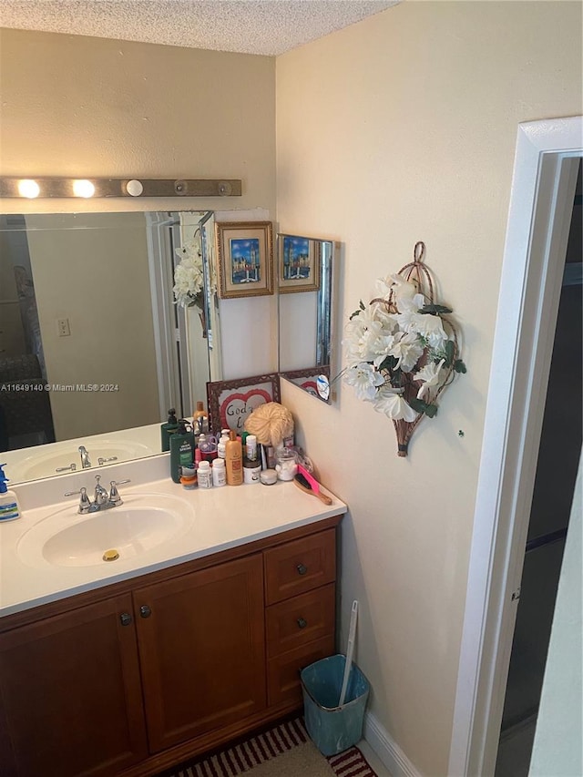 bathroom featuring vanity and a textured ceiling