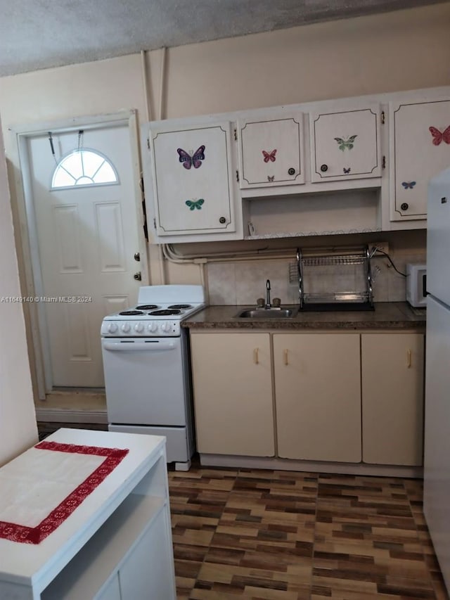 kitchen with sink, a textured ceiling, white appliances, white cabinets, and dark wood-type flooring