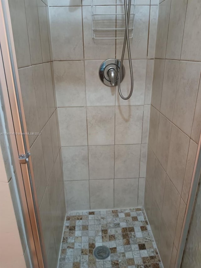 bathroom with a tile shower