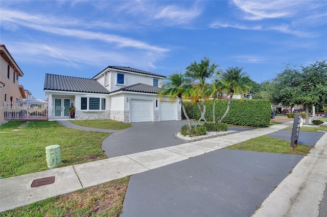 view of front of property with a front yard and a garage