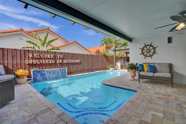 view of swimming pool featuring ceiling fan, a patio, and pool water feature