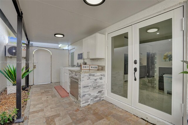 view of patio / terrace with separate washer and dryer, area for grilling, and french doors