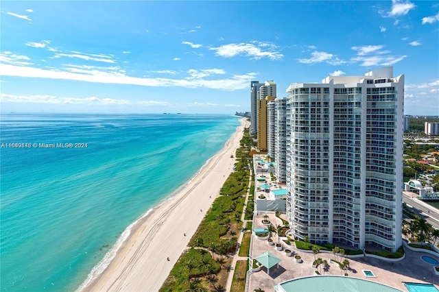 bird's eye view featuring a water view and a beach view