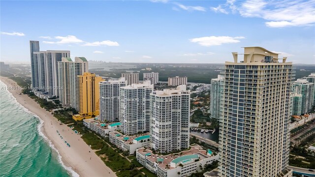 view of city featuring a beach view and a water view