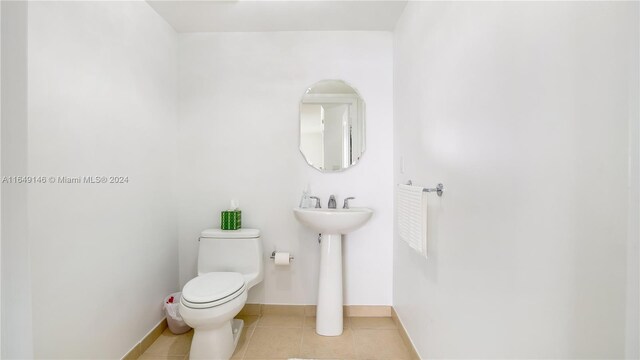 bathroom with tile patterned flooring and toilet