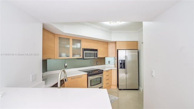 kitchen with light tile patterned floors, crown molding, light brown cabinets, and appliances with stainless steel finishes