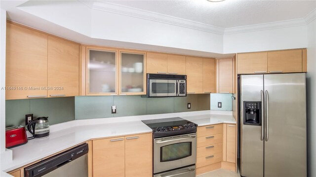 kitchen featuring crown molding, stainless steel appliances, and light brown cabinetry