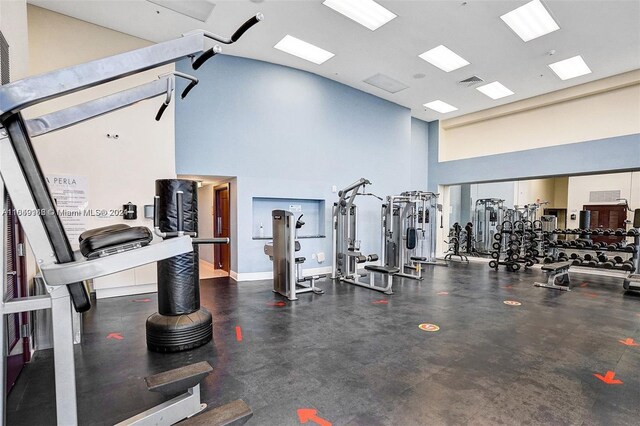 gym featuring a towering ceiling