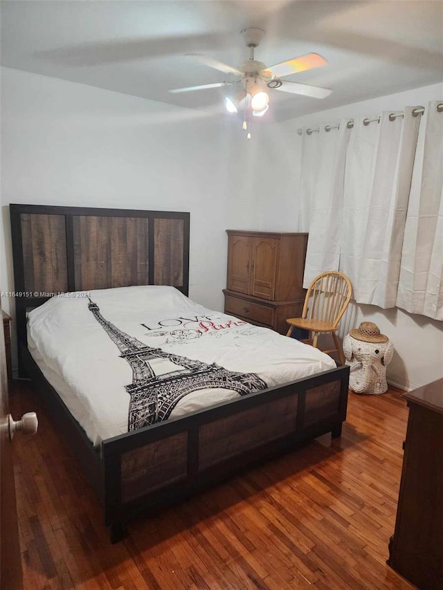 bedroom with ceiling fan and dark hardwood / wood-style flooring