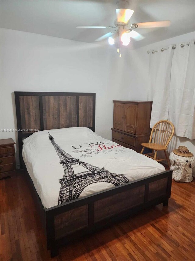 bedroom featuring ceiling fan and dark hardwood / wood-style flooring