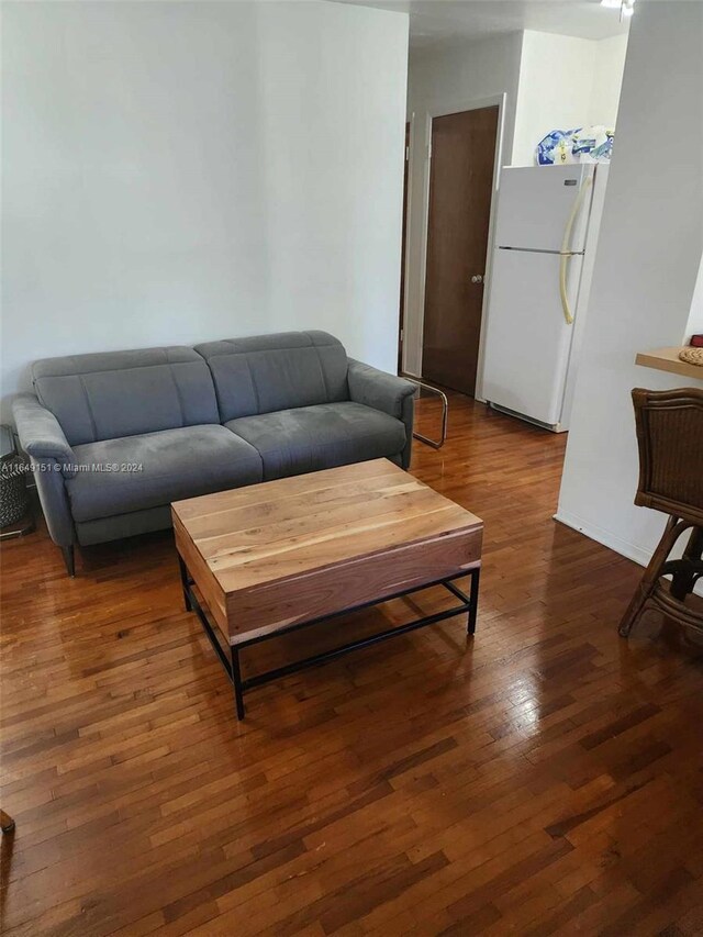 living room with dark hardwood / wood-style flooring