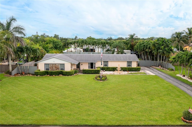 ranch-style home with a front lawn