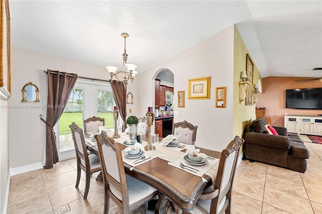 dining room featuring vaulted ceiling, a chandelier, light tile patterned flooring, visible vents, and arched walkways