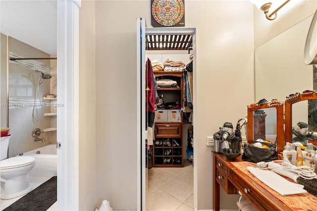 bathroom with toilet, tile patterned flooring, and tub / shower combination