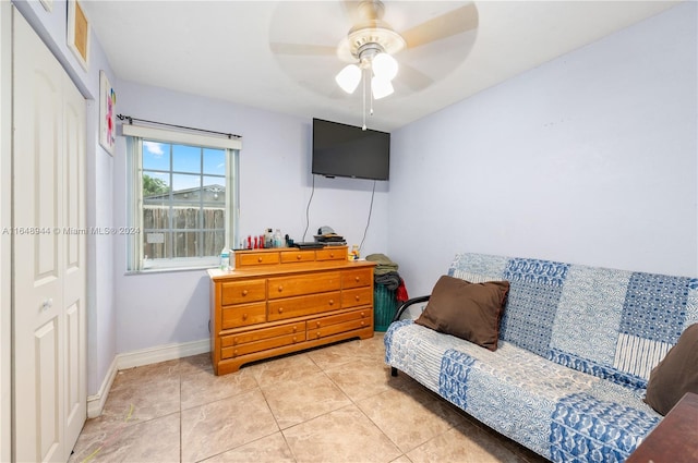 tiled living room with ceiling fan