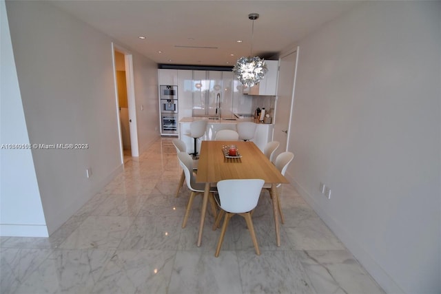 dining area featuring sink and a chandelier