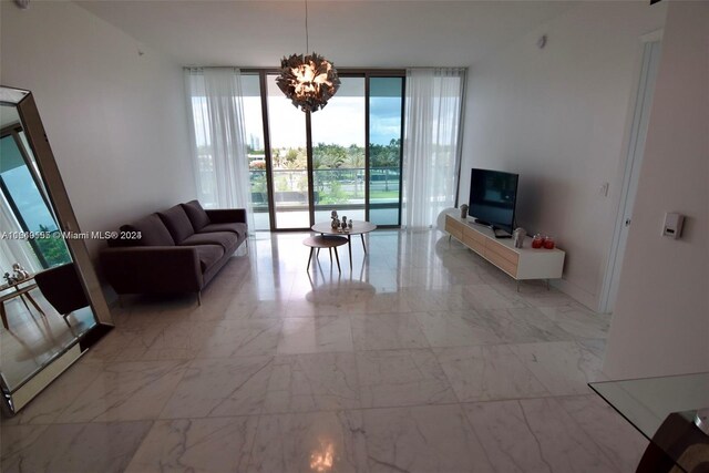 living room with a wall of windows and a notable chandelier