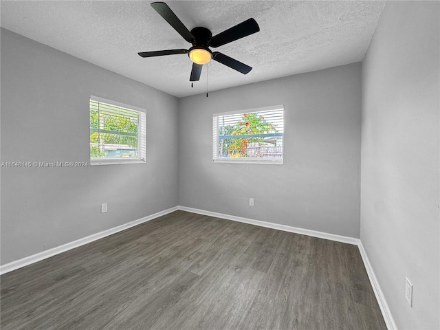 unfurnished room featuring a textured ceiling, plenty of natural light, ceiling fan, and dark hardwood / wood-style flooring