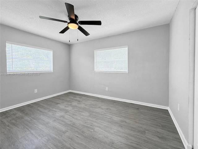 spare room featuring ceiling fan, dark hardwood / wood-style flooring, and a textured ceiling