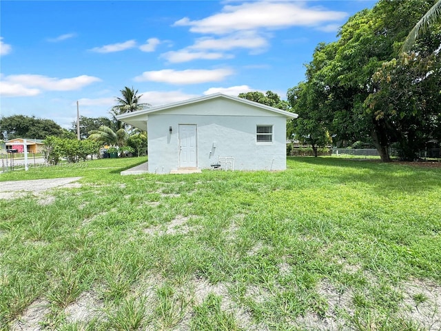 view of side of home with a lawn