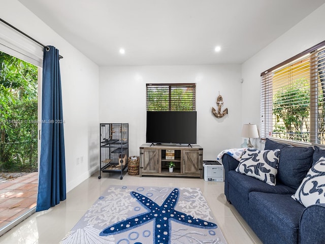 living room with light tile patterned floors and a wealth of natural light