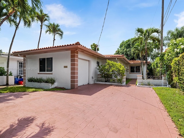 mediterranean / spanish-style house with a garage