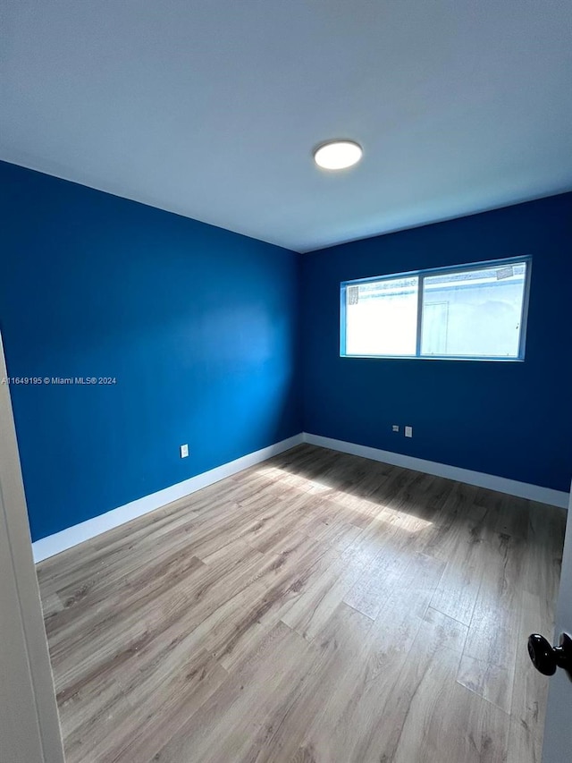 unfurnished room featuring light hardwood / wood-style floors