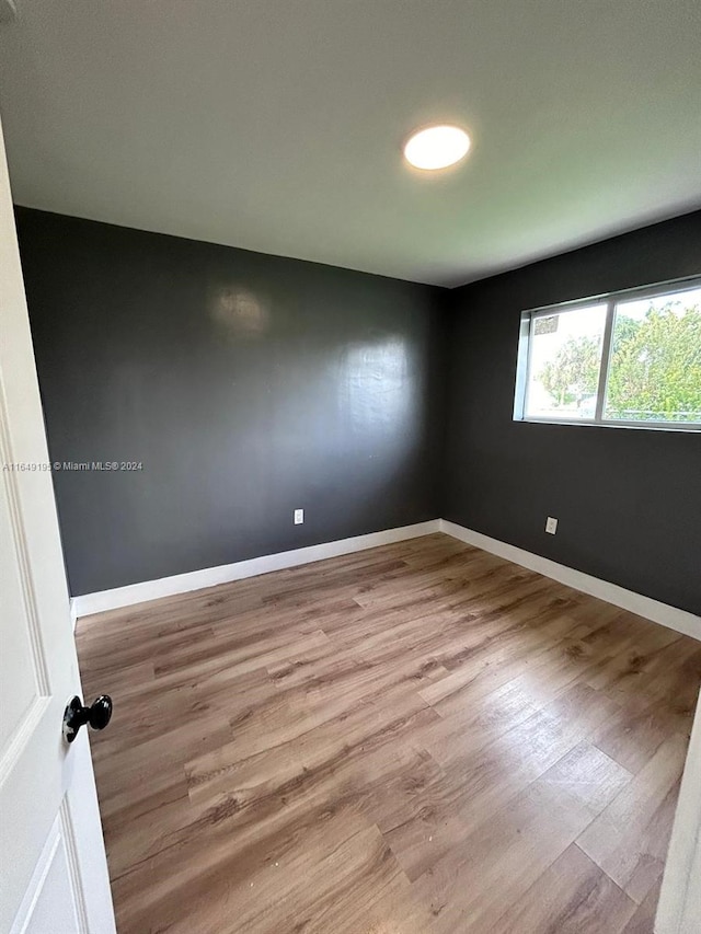 empty room with wood-type flooring