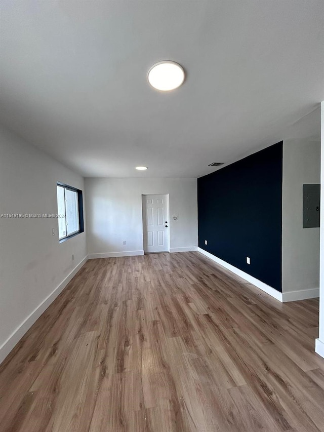 spare room with light hardwood / wood-style flooring