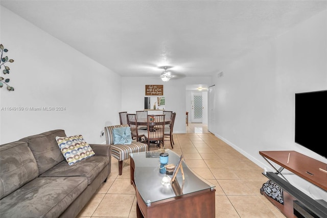 tiled living room with ceiling fan