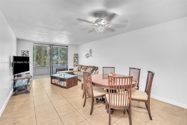 dining area with ceiling fan and light tile patterned flooring