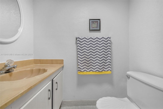 bathroom featuring vanity, toilet, and tile patterned floors