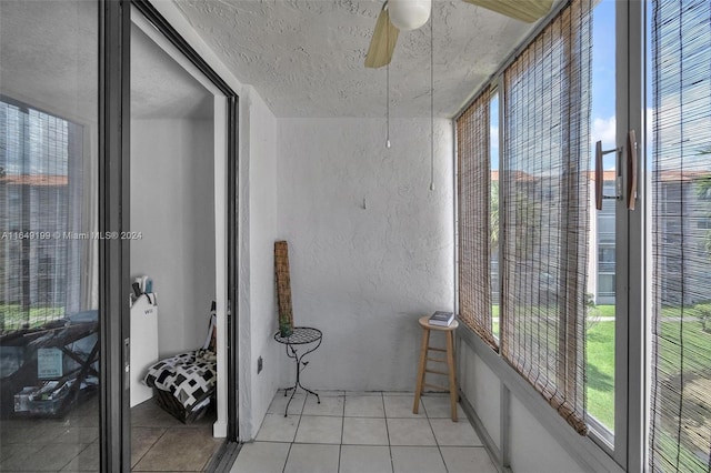 sunroom featuring ceiling fan