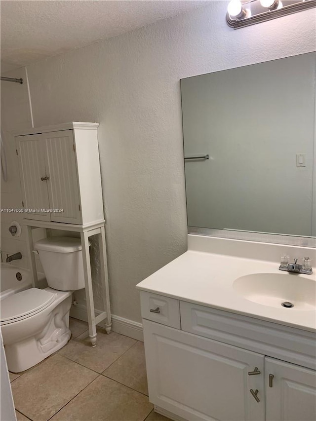 bathroom featuring tile patterned flooring, baseboards, toilet, shower / tub combination, and vanity