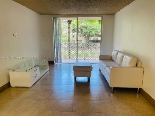 tiled living room with a textured ceiling