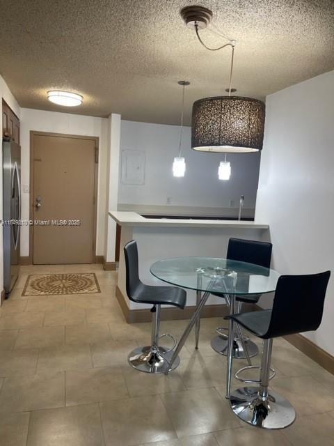 dining space with a textured ceiling