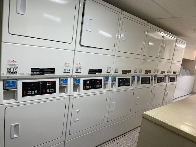 clothes washing area featuring stacked washer and dryer and washing machine and dryer