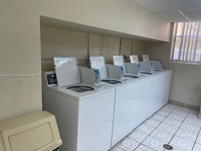 laundry area featuring light tile patterned floors and washer and clothes dryer