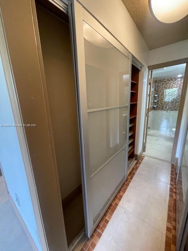 bathroom featuring tile patterned floors and a textured ceiling