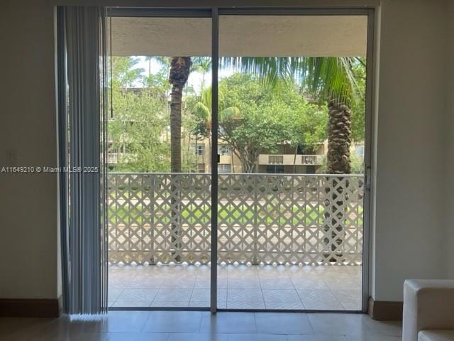 doorway to outside featuring tile patterned floors