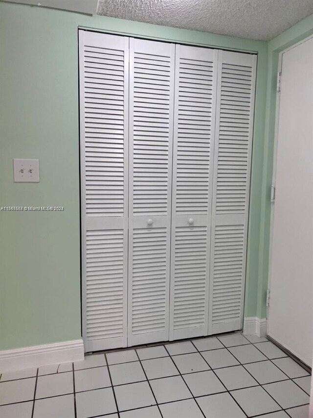 interior details with tile patterned flooring and a textured ceiling