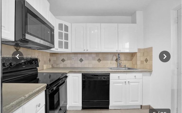 kitchen featuring black appliances, tasteful backsplash, white cabinetry, and sink