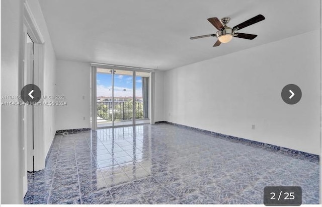 tiled empty room with expansive windows and ceiling fan