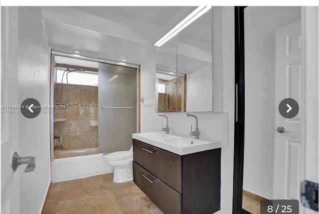 full bathroom with tile patterned flooring, toilet, tiled shower / bath combo, and vanity